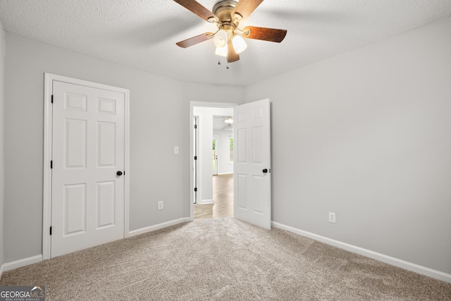 615 Coan Dr, Locust Grove, GA 30248 - unfurnished bedroom with carpet floors, a ceiling fan, and a textured ceiling