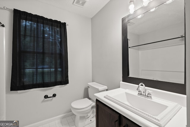 615 Coan Dr, Locust Grove, GA 30248 - bathroom with vanity, tile patterned floors, and a textured ceiling