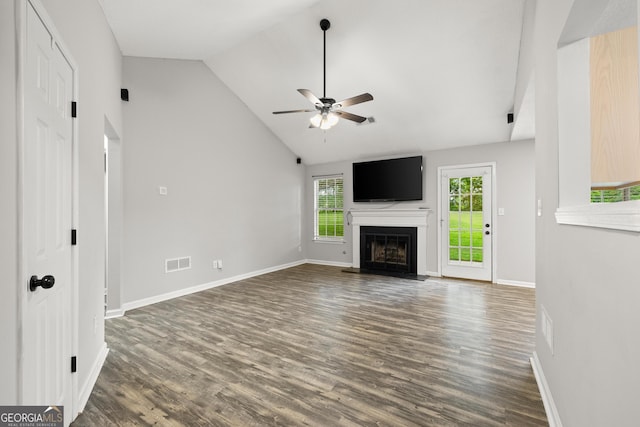 615 Coan Dr, Locust Grove, GA 30248 - unfurnished living room with dark wood finished floors, ceiling fan, lofted ceiling, and a fireplace with raised hearth