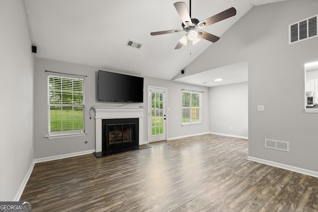 615 Coan Dr, Locust Grove, GA 30248 - unfurnished living room featuring a ceiling fan, wood finished floors, a fireplace with raised hearth, and high vaulted ceiling