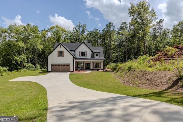 181 S Chattahoochee Dr, Hogansville, GA 30230 - modern farmhouse featuring covered porch, concrete driveway, a front lawn, a garage, and board and batten siding