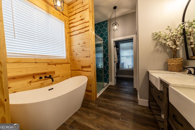 181 S Chattahoochee Dr, Hogansville, GA 30230 - bathroom featuring wood finished floors, vanity, a freestanding tub, wooden walls, and a stall shower