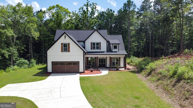181 S Chattahoochee Dr, Hogansville, GA 30230 - modern inspired farmhouse featuring a porch, concrete driveway, a front yard, board and batten siding, and a garage