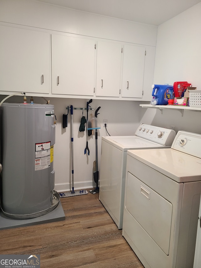 723 Fricks Ln, Rossville, GA 30741 - laundry room featuring water heater, washing machine and dryer, wood finished floors, and cabinet space