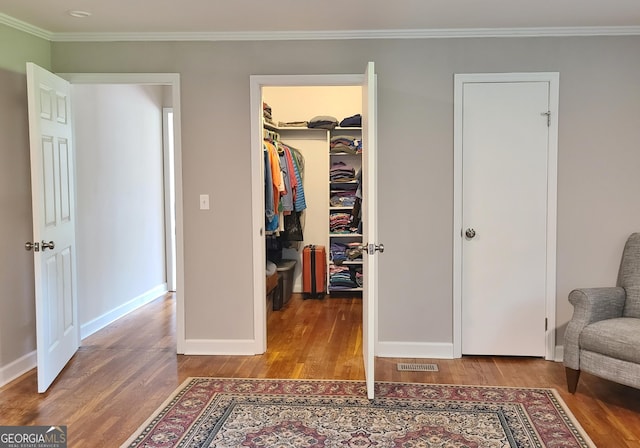 723 Fricks Ln, Rossville, GA 30741 - bedroom with a walk in closet, wood finished floors, crown molding, and a closet
