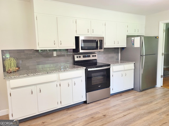 723 Fricks Ln, Rossville, GA 30741 - kitchen featuring appliances with stainless steel finishes, tasteful backsplash, white cabinetry, and light wood-type flooring