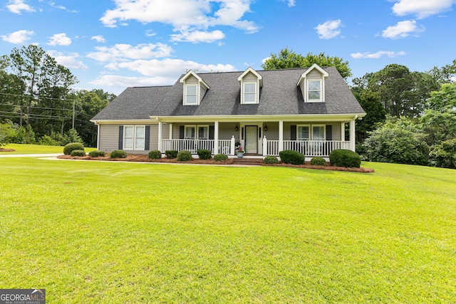 100 Merrill Dr, Lagrange, GA 30241 - new england style home featuring a front yard, covered porch, and a shingled roof