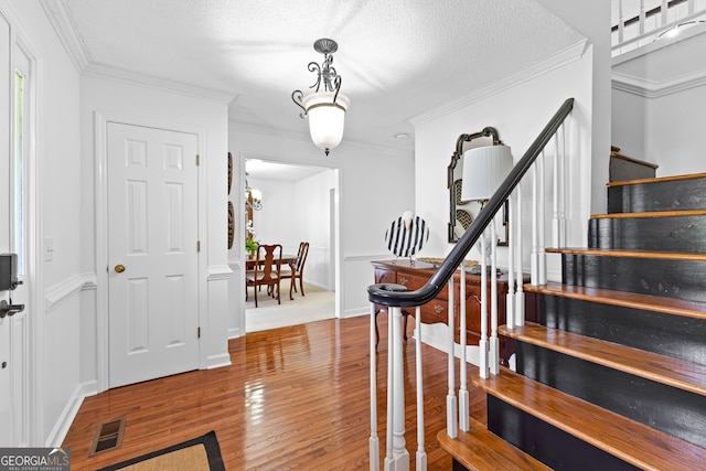 100 Merrill Dr, Lagrange, GA 30241 - entrance foyer with stairs, wood finished floors, crown molding, a textured ceiling, and a wainscoted wall