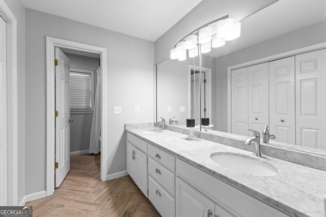 100 Merrill Dr, Lagrange, GA 30241 - bathroom with double vanity, a closet, and a textured ceiling