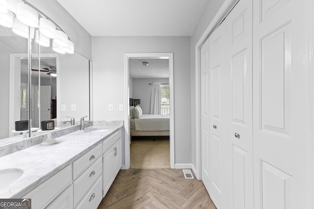 100 Merrill Dr, Lagrange, GA 30241 - ensuite bathroom with a textured ceiling, a closet, double vanity, and ceiling fan