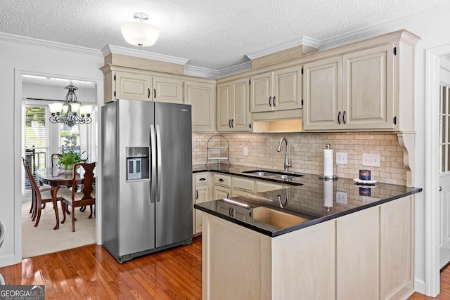100 Merrill Dr, Lagrange, GA 30241 - kitchen featuring stainless steel fridge with ice dispenser, a peninsula, wood finished floors, a textured ceiling, and a chandelier