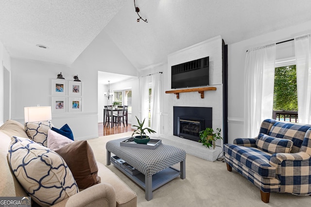 100 Merrill Dr, Lagrange, GA 30241 - living area featuring light colored carpet, a fireplace, vaulted ceiling, a chandelier, and a textured ceiling