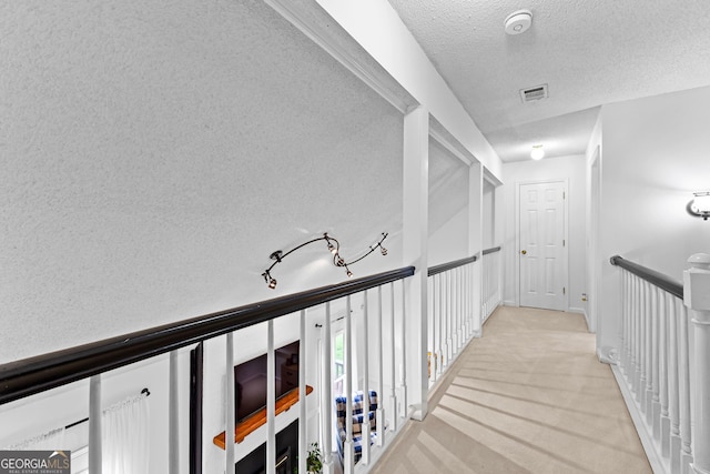 100 Merrill Dr, Lagrange, GA 30241 - corridor featuring a textured ceiling and light carpet