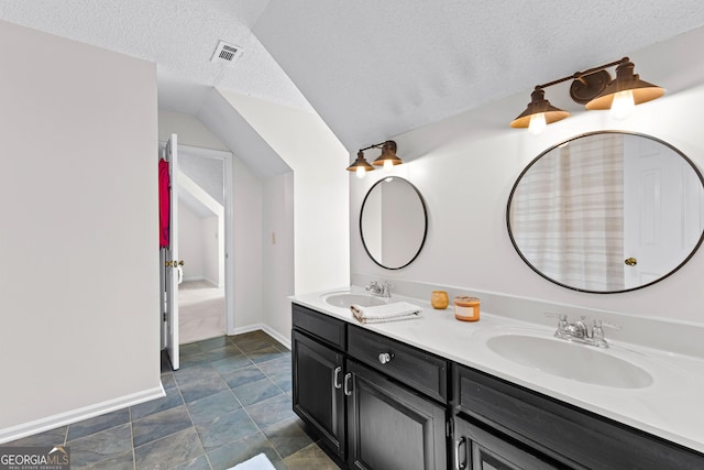 100 Merrill Dr, Lagrange, GA 30241 - bathroom with double vanity, a textured ceiling, and lofted ceiling