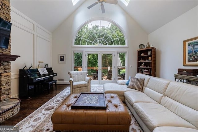 525 Avala Ct, Johns Creek, GA 30022 - living room featuring high vaulted ceiling, a skylight, a ceiling fan, dark wood finished floors, and french doors