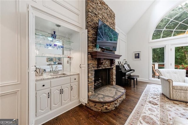 525 Avala Ct, Johns Creek, GA 30022 - living area with dark wood finished floors, a stone fireplace, and high vaulted ceiling