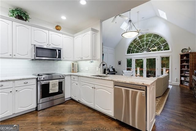525 Avala Ct, Johns Creek, GA 30022 - kitchen with stainless steel appliances, a peninsula, dark wood-style flooring, white cabinets, and recessed lighting