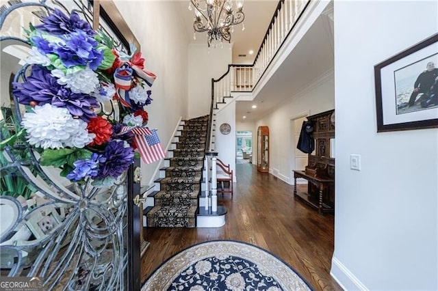 525 Avala Ct, Johns Creek, GA 30022 - foyer entrance featuring stairs, wood finished floors, a chandelier, ornamental molding, and a high ceiling
