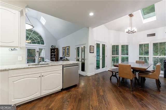 525 Avala Ct, Johns Creek, GA 30022 - kitchen featuring stainless steel dishwasher, a chandelier, a skylight, dark wood-style floors, and white cabinetry