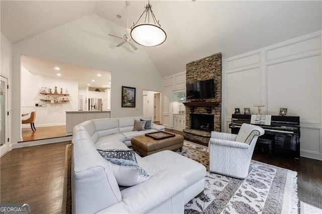 525 Avala Ct, Johns Creek, GA 30022 - living area featuring wood finished floors, high vaulted ceiling, a decorative wall, a stone fireplace, and ceiling fan