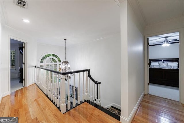 525 Avala Ct, Johns Creek, GA 30022 - hallway featuring a chandelier, ornamental molding, hardwood / wood-style flooring, recessed lighting, and an upstairs landing