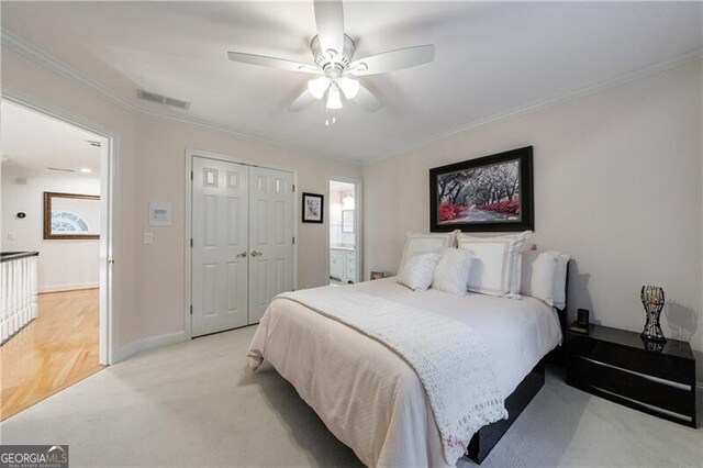 525 Avala Ct, Johns Creek, GA 30022 - bedroom featuring light colored carpet, ornamental molding, a closet, and a ceiling fan