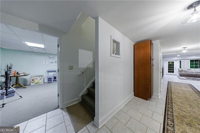 525 Avala Ct, Johns Creek, GA 30022 - corridor featuring stairway, light tile patterned floors, and light colored carpet