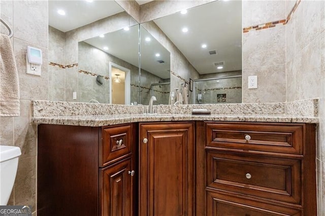 525 Avala Ct, Johns Creek, GA 30022 - full bathroom featuring tile walls, a shower stall, vanity, and recessed lighting