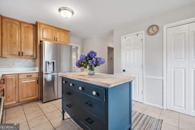 3220 Casteel Rd, Marietta, GA 30062 - kitchen featuring stainless steel refrigerator with ice dispenser, light tile patterned flooring, butcher block countertops, tasteful backsplash, and a kitchen island