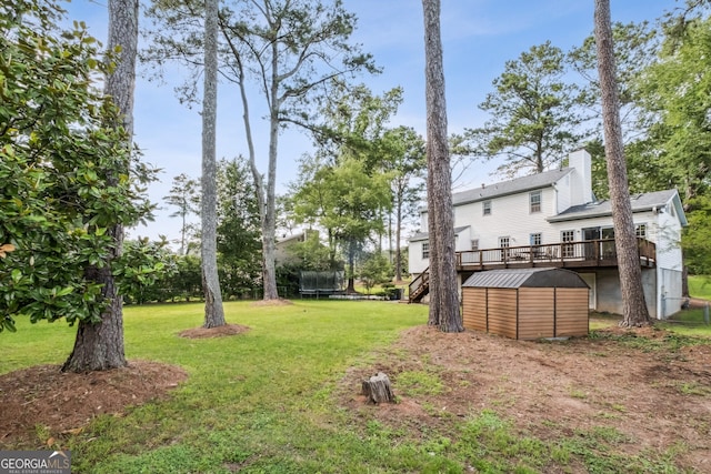 3220 Casteel Rd, Marietta, GA 30062 - view of grassy yard featuring a trampoline, a shed, and a wooden deck