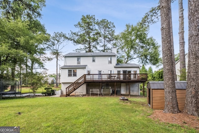 3220 Casteel Rd, Marietta, GA 30062 - back of property featuring a trampoline, a deck, a storage unit, stairway, and a lawn