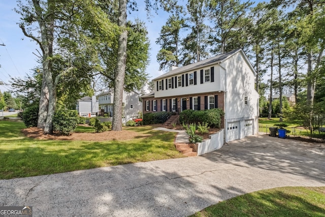 3220 Casteel Rd, Marietta, GA 30062 - colonial house with an attached garage, driveway, brick siding, and a front lawn