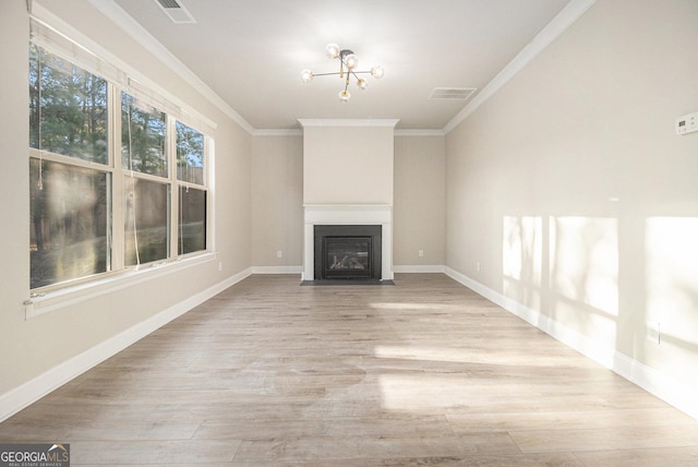 7691 Brazos Trl, Fairburn, GA 30213 - unfurnished living room featuring crown molding, wood finished floors, a fireplace with flush hearth, and a chandelier