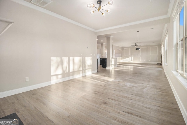 7691 Brazos Trl, Fairburn, GA 30213 - unfurnished living room with wood finished floors, a chandelier, ceiling fan, and crown molding