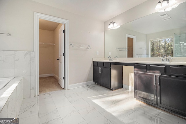 7691 Brazos Trl, Fairburn, GA 30213 - full bath featuring double vanity, marble finish floors, a spacious closet, and a relaxing tiled tub