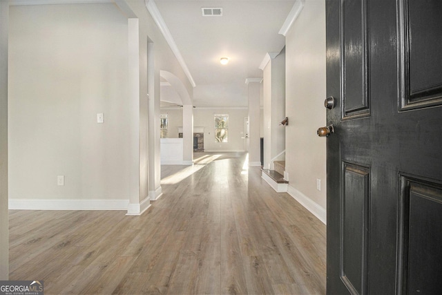 7691 Brazos Trl, Fairburn, GA 30213 - foyer with crown molding, light wood-style floors, and stairs