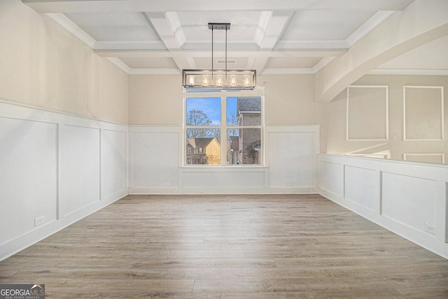 7691 Brazos Trl, Fairburn, GA 30213 - unfurnished dining area with a decorative wall, a chandelier, wood finished floors, beam ceiling, and coffered ceiling
