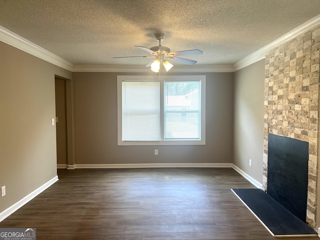 6300 Creekford Ln, Lithonia, GA 30058 - unfurnished living room featuring ceiling fan, a textured ceiling, a fireplace, crown molding, and dark wood-style floors