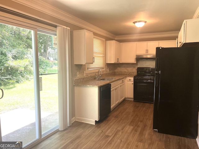 6300 Creekford Ln, Lithonia, GA 30058 - kitchen featuring black appliances, under cabinet range hood, white cabinets, tasteful backsplash, and ornamental molding