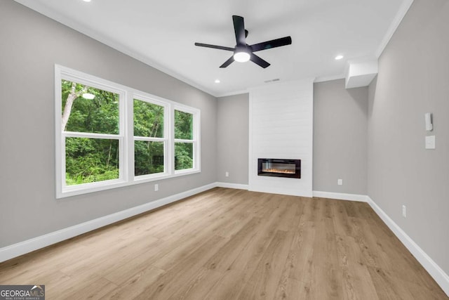 155 Carey St, Franklin Springs, GA 30662 - unfurnished living room with light wood-style flooring, a fireplace, a ceiling fan, recessed lighting, and crown molding
