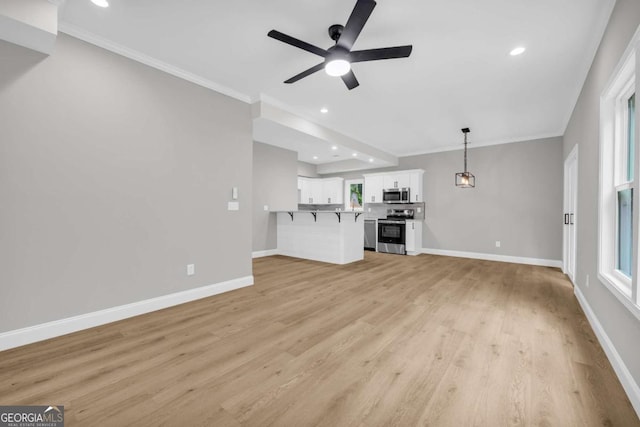 155 Carey St, Franklin Springs, GA 30662 - unfurnished living room featuring a ceiling fan, crown molding, plenty of natural light, light wood-style floors, and recessed lighting