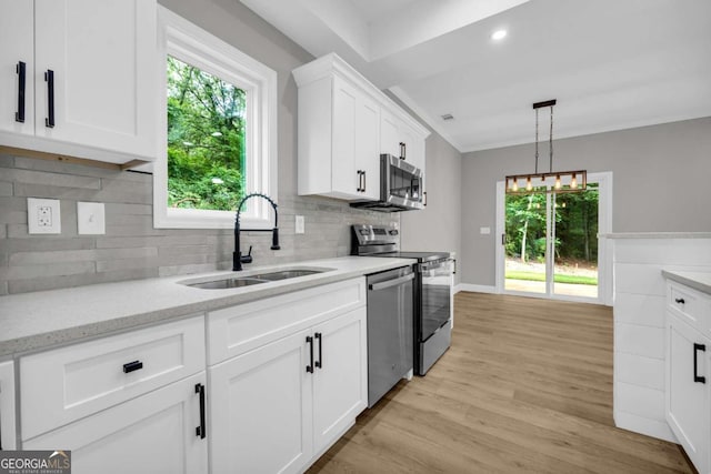 155 Carey St, Franklin Springs, GA 30662 - kitchen with stainless steel appliances, light wood-style flooring, white cabinets, healthy amount of natural light, and recessed lighting