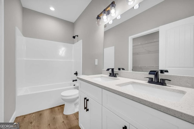 155 Carey St, Franklin Springs, GA 30662 - full bathroom with double vanity, wood finished floors, bathing tub / shower combination, and recessed lighting