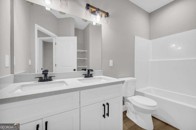 155 Carey St, Franklin Springs, GA 30662 - full bathroom featuring double vanity, wood finished floors, and shower / washtub combination