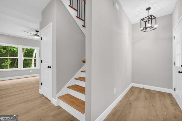 155 Carey St, Franklin Springs, GA 30662 - stairs featuring wood finished floors, a chandelier, and a ceiling fan