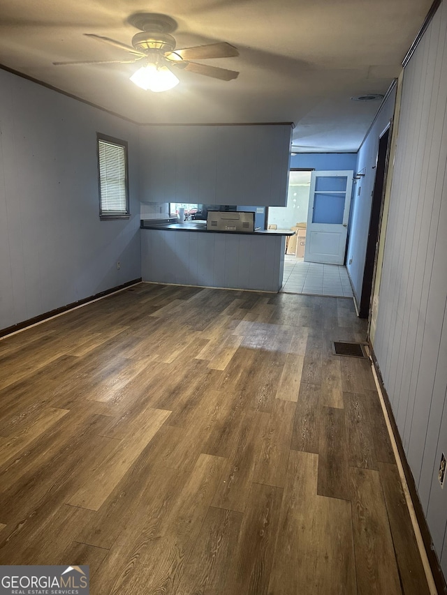 26 Fleming St, Royston, GA 30662 - unfurnished living room with dark wood-type flooring, ceiling fan, and plenty of natural light