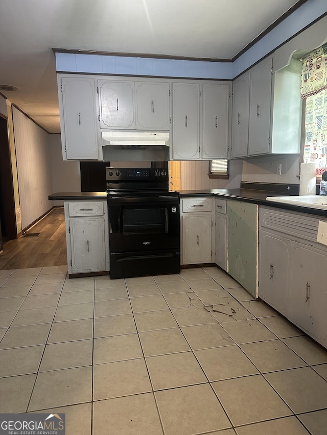 26 Fleming St, Royston, GA 30662 - kitchen featuring black range with electric cooktop, under cabinet range hood, dark countertops, and light tile patterned floors