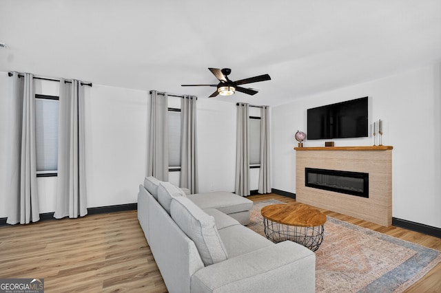 1120 Glass Bridge Rd, Lagrange, GA 30240 - living room with ceiling fan, a glass covered fireplace, and light wood finished floors
