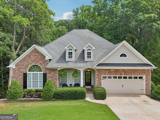 8485 Anchor On Lanier Ct, Gainesville, GA 30506 - view of front of home featuring stone siding, driveway, a garage, a front yard, and roof with shingles