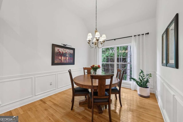 8485 Anchor On Lanier Ct, Gainesville, GA 30506 - dining area with a decorative wall, a chandelier, light wood-style floors, lofted ceiling, and a wainscoted wall